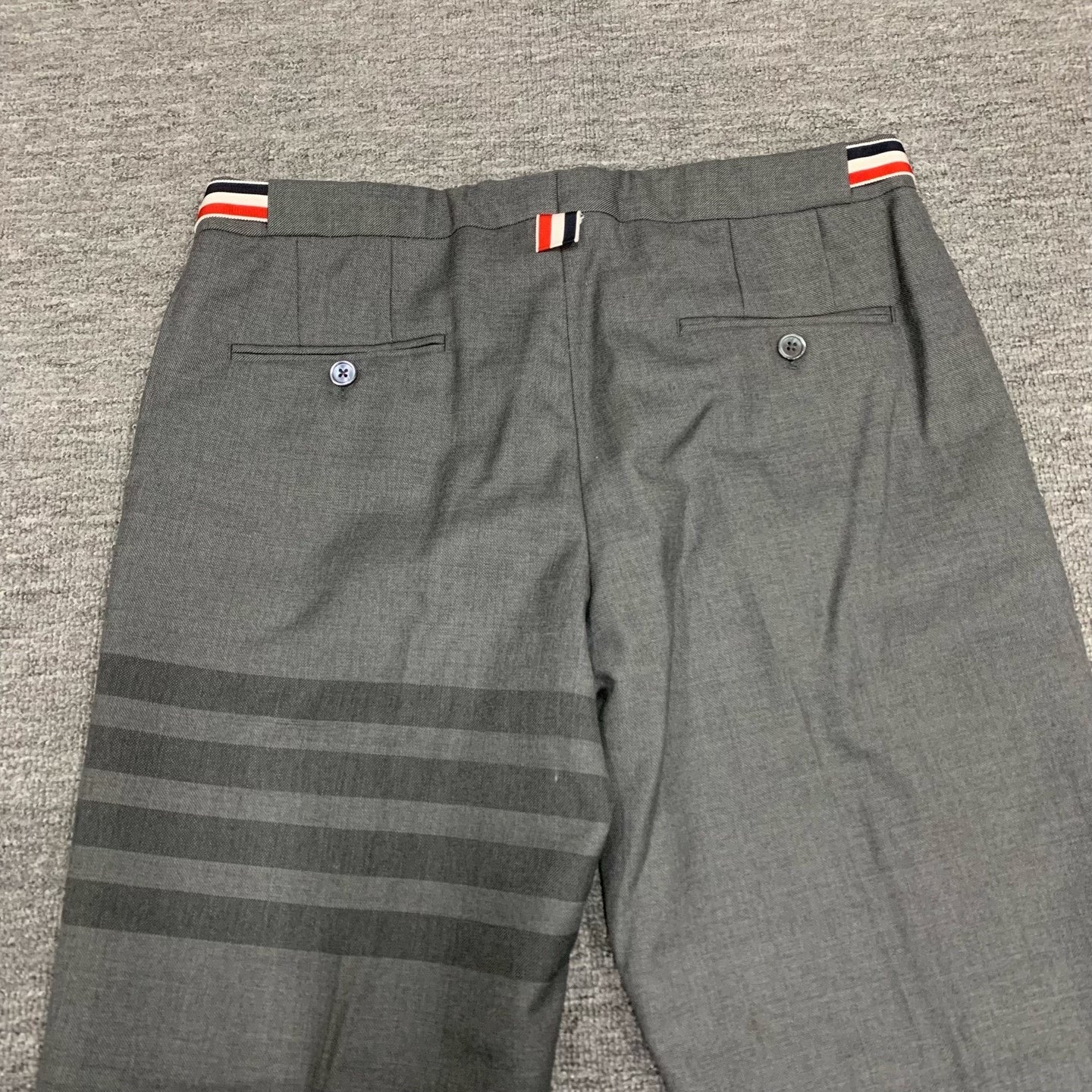 gray striped wool suit trousers by Thom Browne