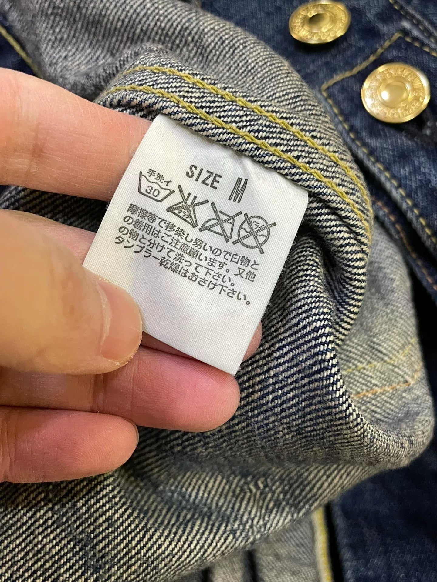 stylish blue denim jacket with gold buttons