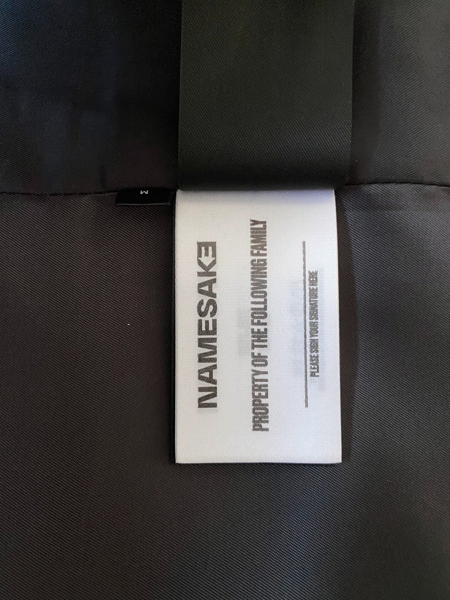 beige baseball jacket with leather sleeves