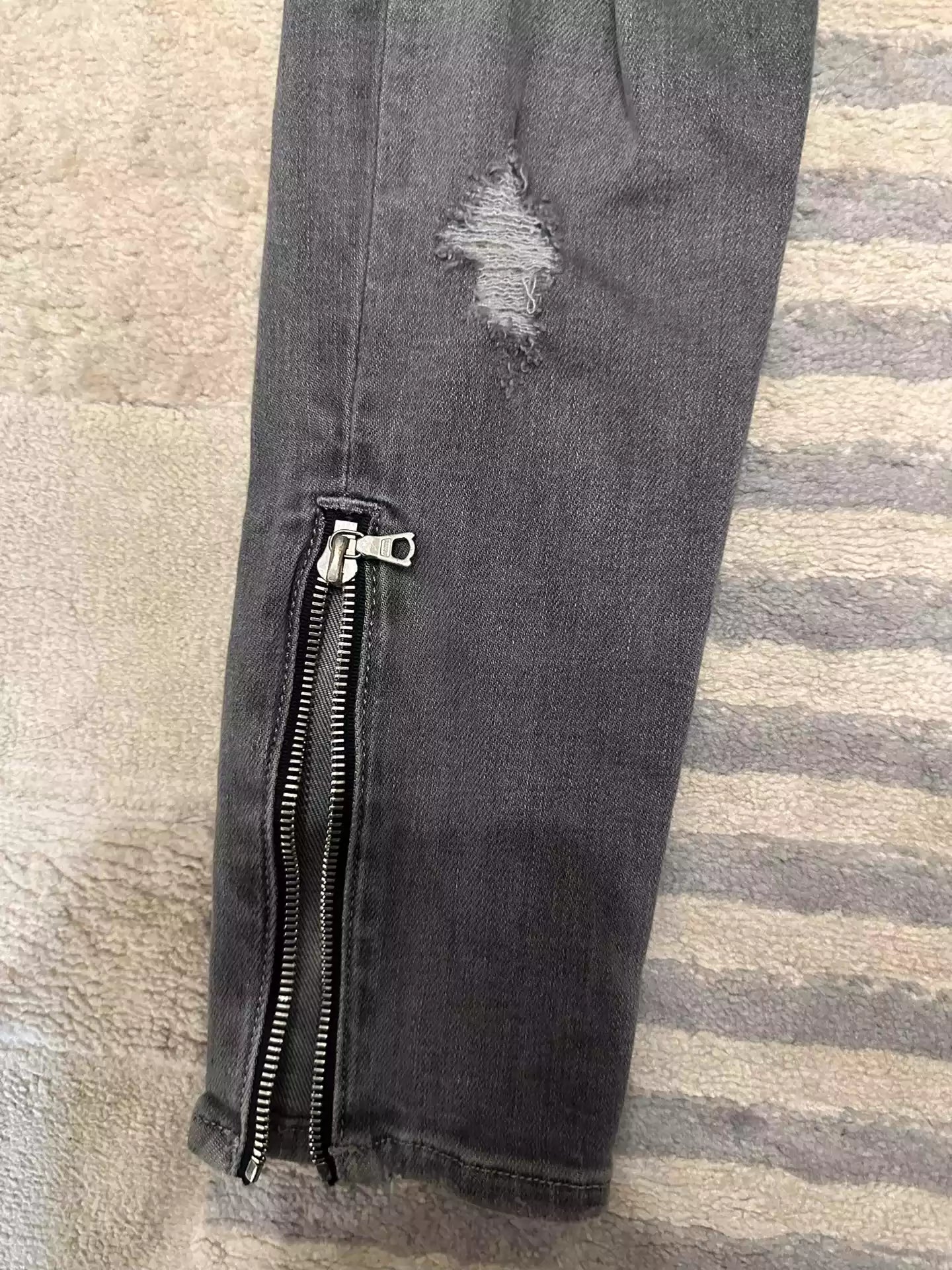 Amiri jeans with holes in the side zipper
