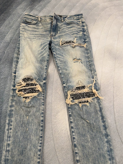 Amiri blue yellowed MX1 knife cuts through holes to make old cashew flower patchwork patch jeans