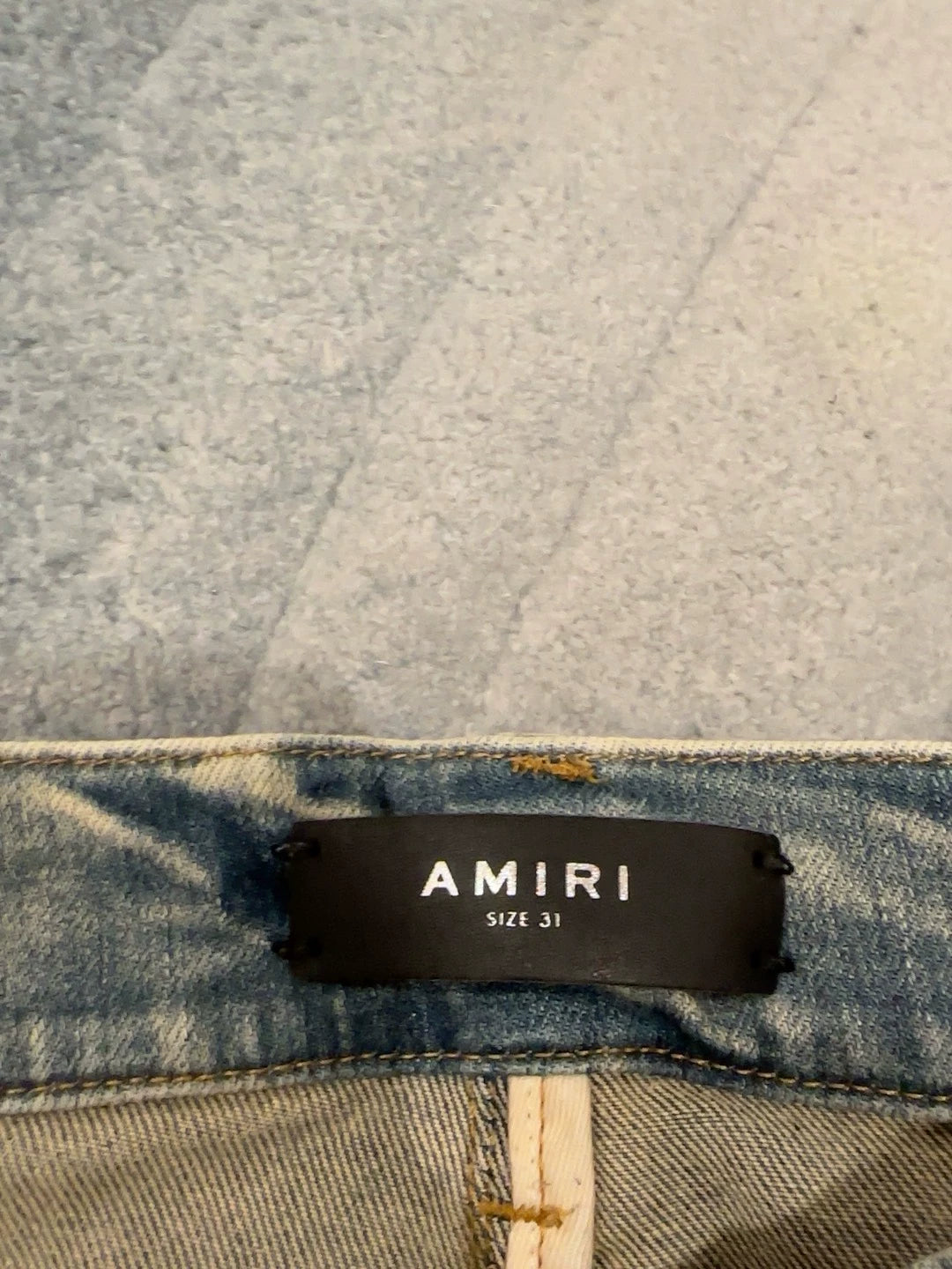 Amiri blue yellowed MX1 knife cuts through holes to make old cashew flower patchwork patch jeans