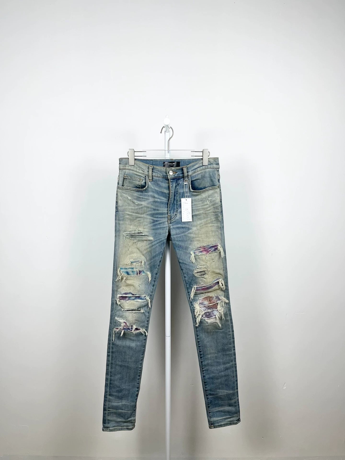 Amiri light blue color rendering ripped jeans