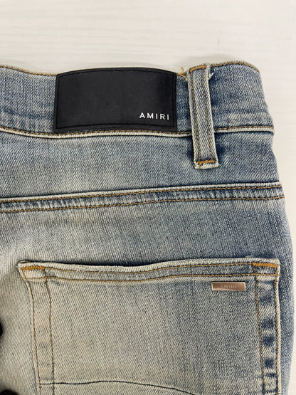 Amiri light blue color rendering ripped jeans