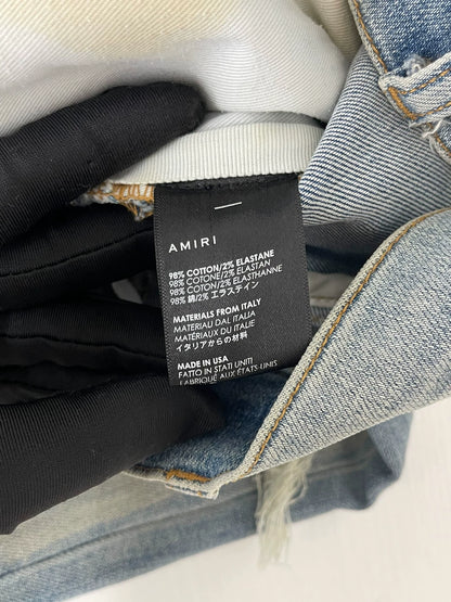 Amiri light blue color rendering ripped jeans