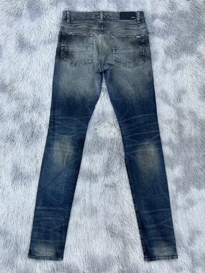 Amiri oil-stained metal damaged jeans - - DMC