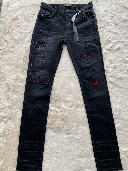 Amiri washed black and red patchwork fabric logo letter jeans