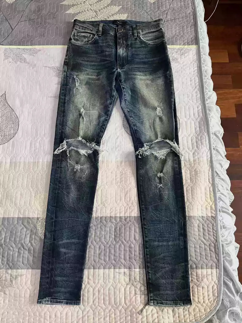 Amiri's old oil stain distressed damaged knees jeans