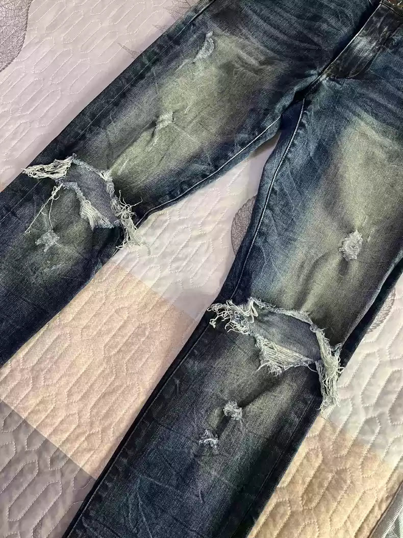 Amiri's old oil stain distressed damaged knees jeans