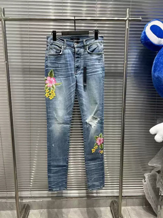 Amiri floral embroidery destroys light colored washed blue jeans