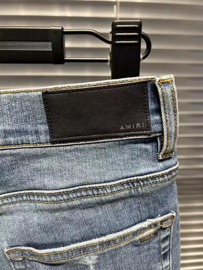 Amiri floral embroidery destroys light colored washed blue jeans