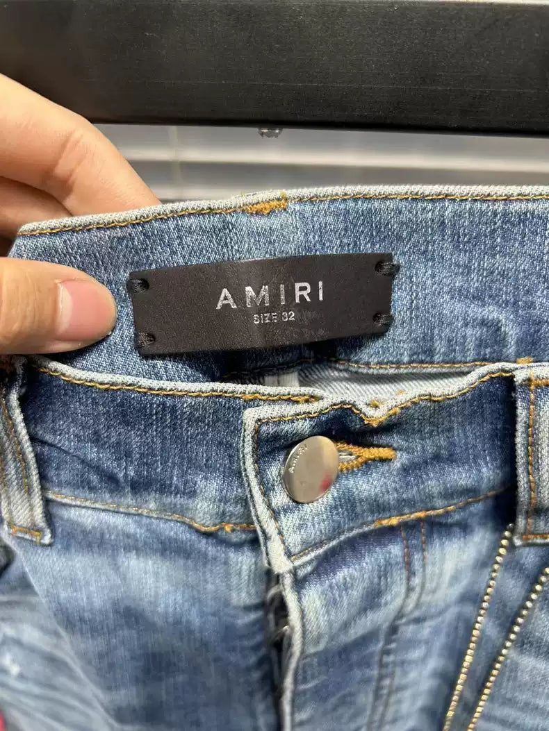 Amiri floral embroidery destroys light colored washed blue jeans