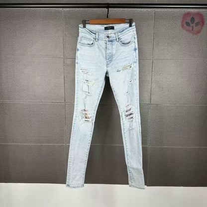 Amiri's new light colored coconut tree patchwork knife cut jeans