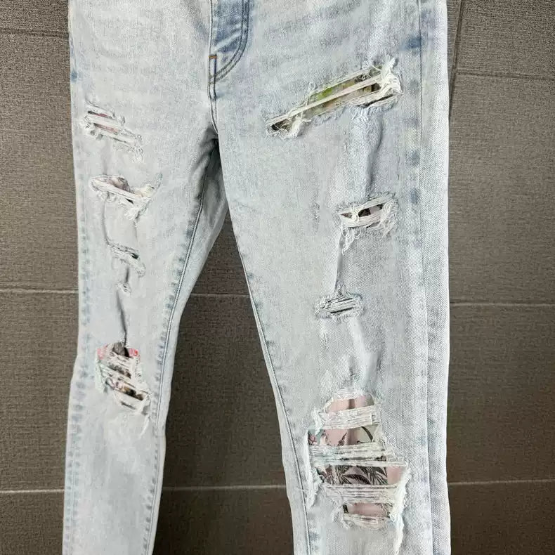 Amiri's new light colored coconut tree patchwork knife cut jeans