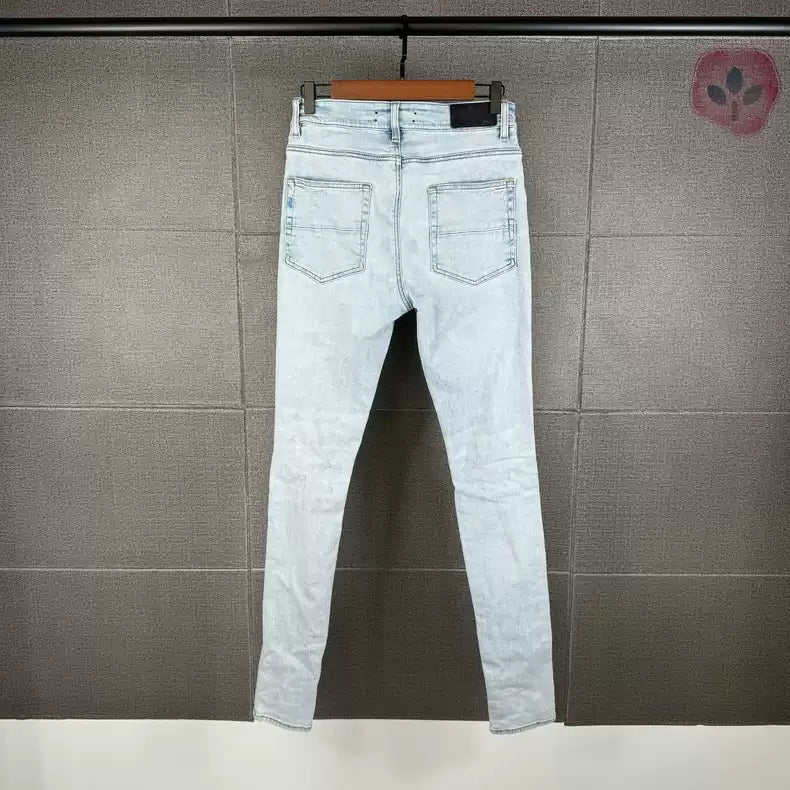 Amiri's new light colored coconut tree patchwork knife cut jeans