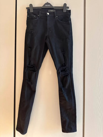 Amiri black ripped leg repair jeans