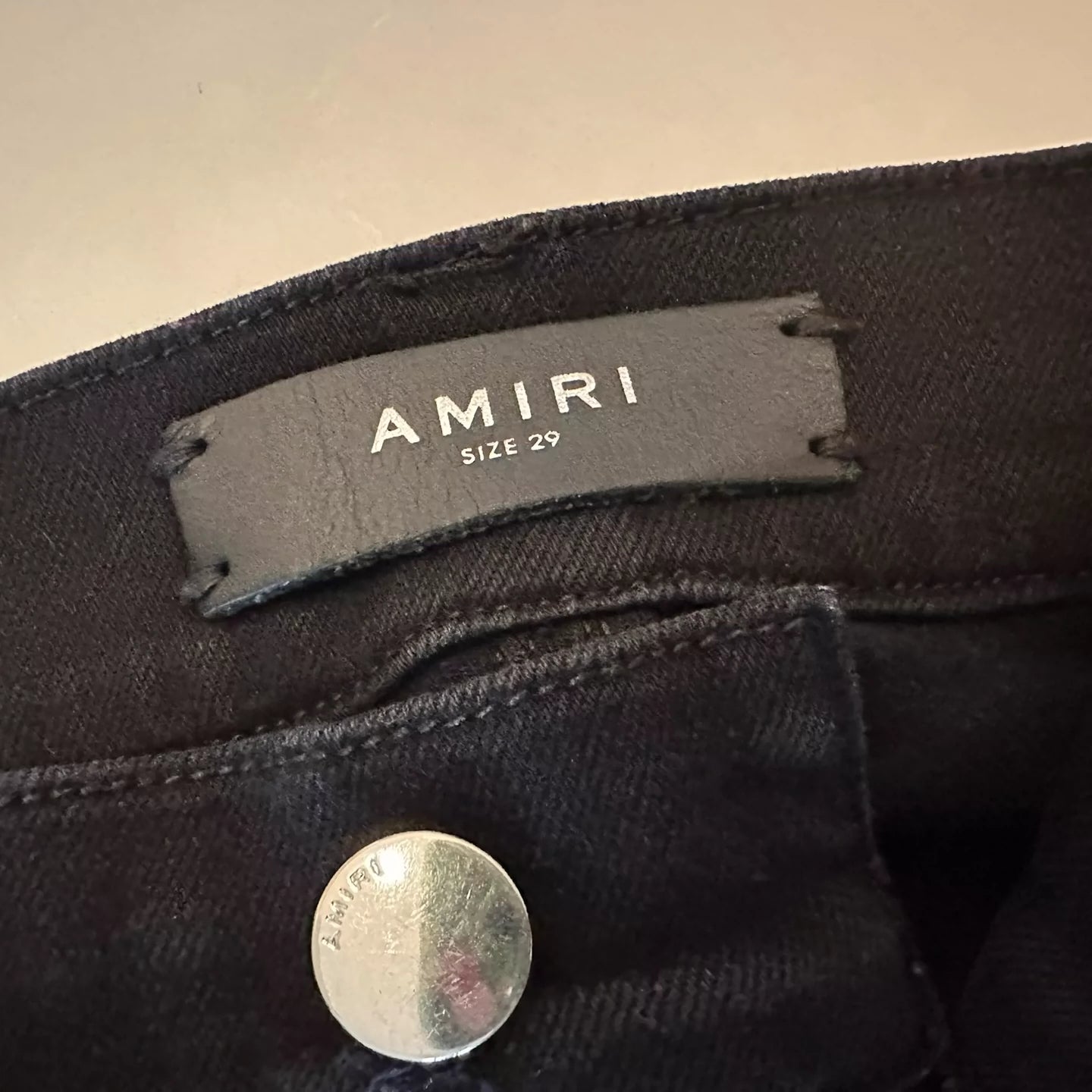 Amiri black ripped leg repair jeans