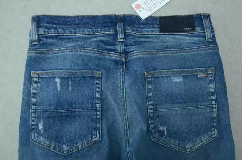 Amiri Blue washed cat paw big damage jeans