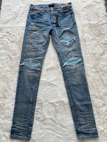 Amiri washed blue and blue patchwork logo jeans