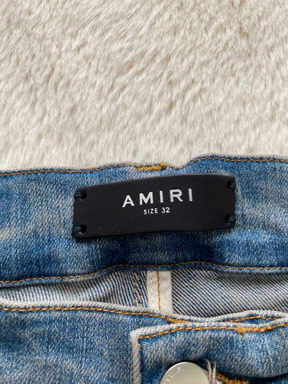 Amiri washed blue and blue patchwork logo jeans