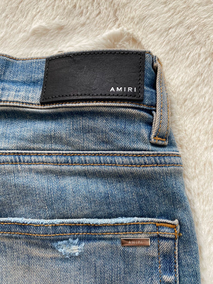 Amiri washed blue and blue patchwork logo jeans