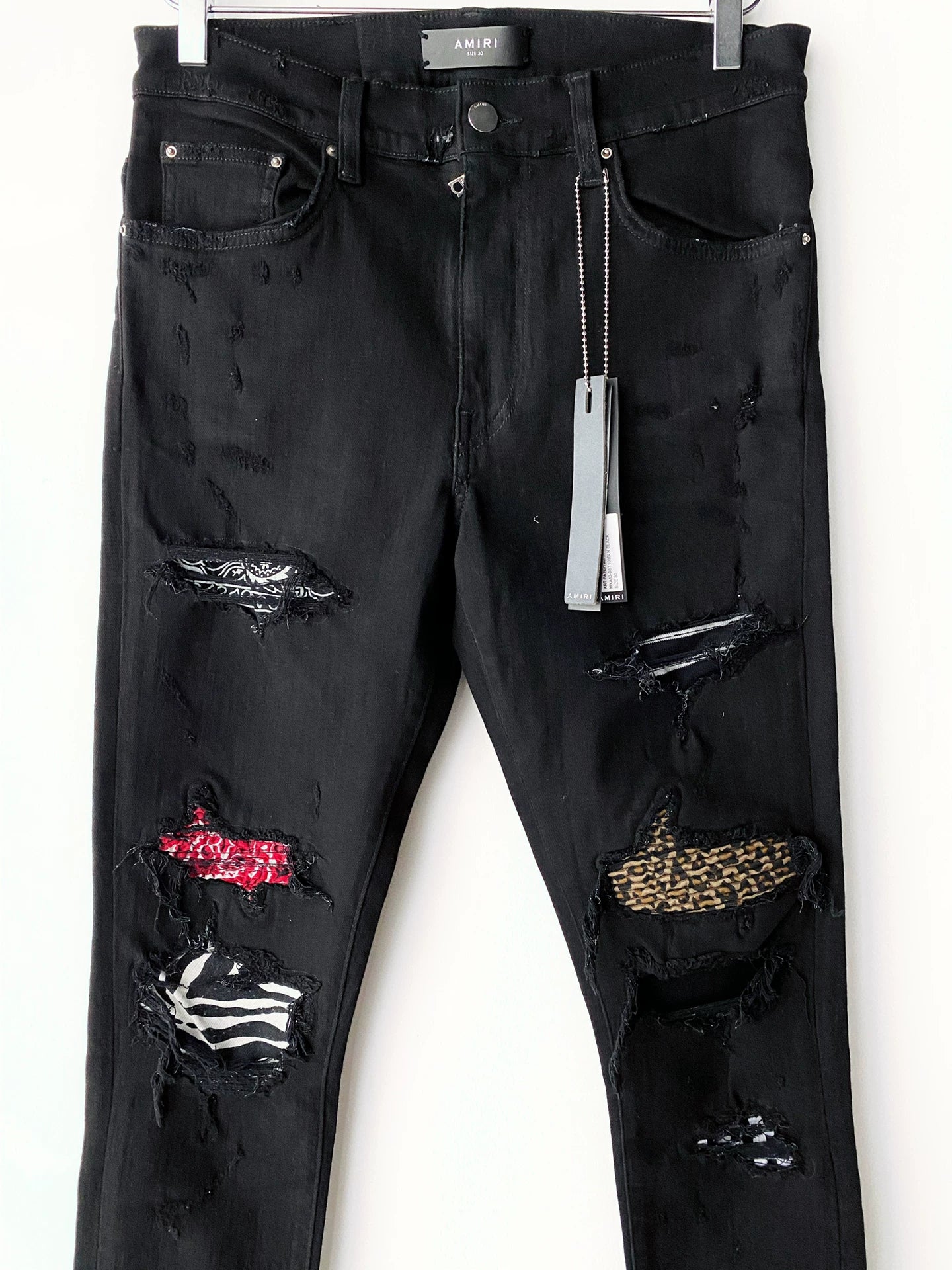 Amiri checkerboard cashew flower splatter art patch black jeans