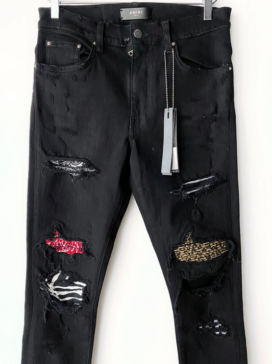 Amiri checkerboard cashew flower splatter art patch black jeans