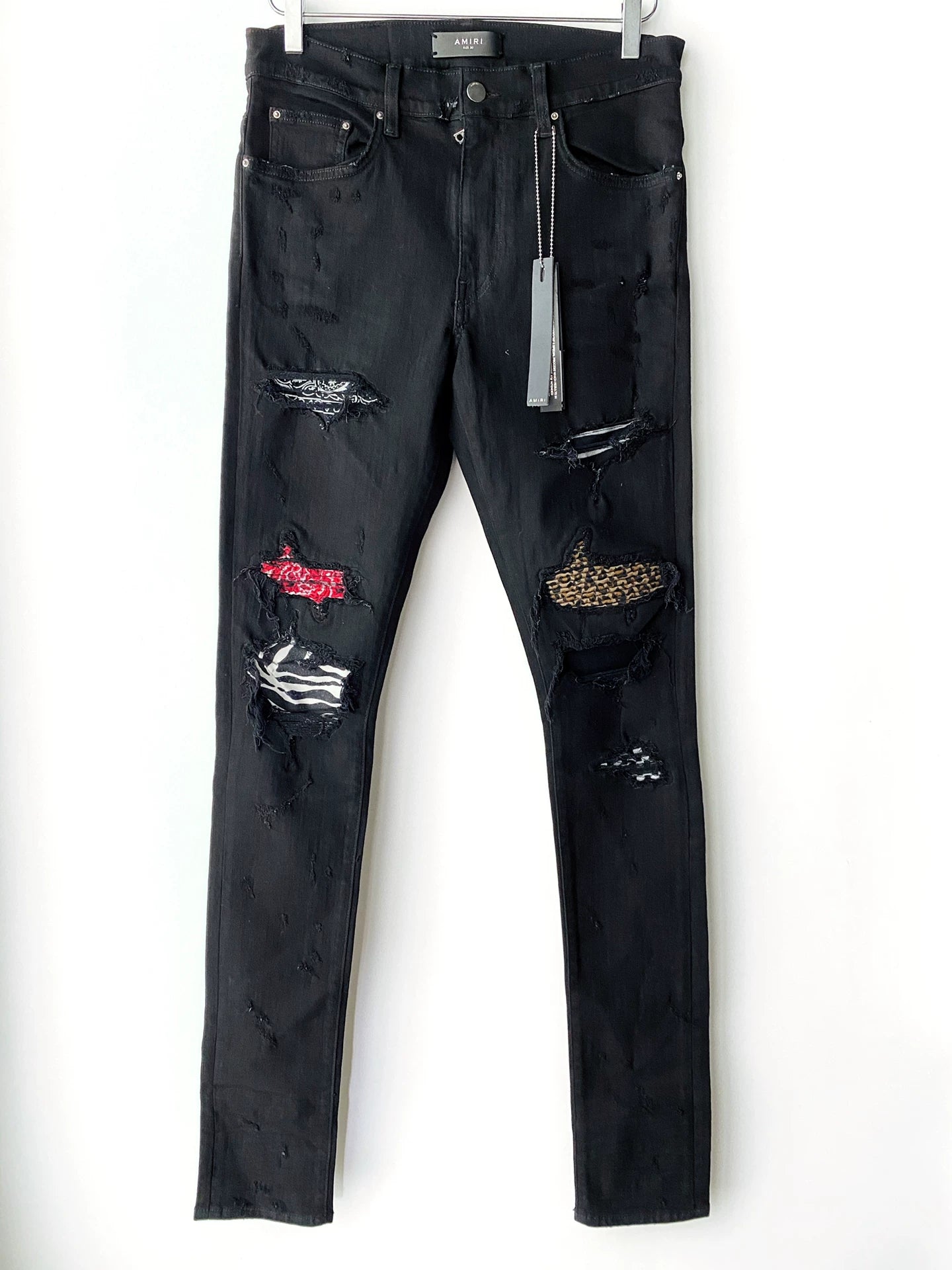 Amiri checkerboard cashew flower splatter art patch black jeans