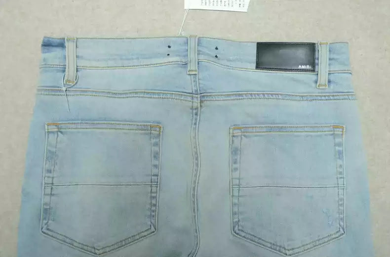 Amiri Blue washed knife cuts and damages jeans and casual pants