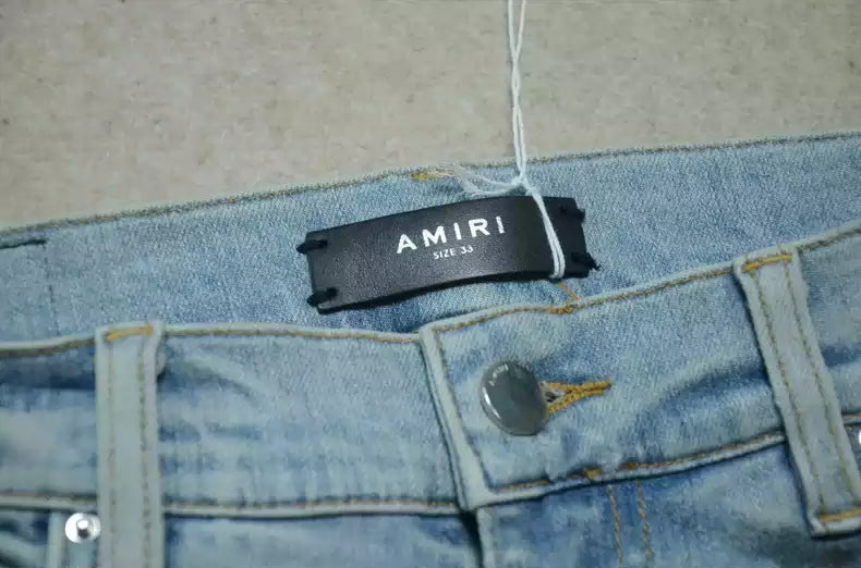 Amiri Blue washed knife cuts and damages jeans and casual pants