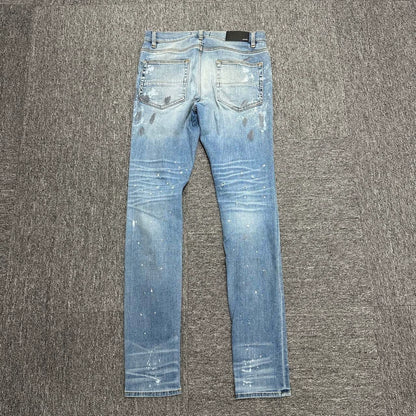 Amiri single knee tear splashed ink jeans