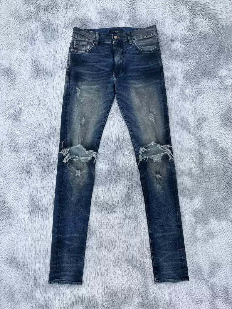 Amiri oil stains, metal washings, worn knees, damaged jeans