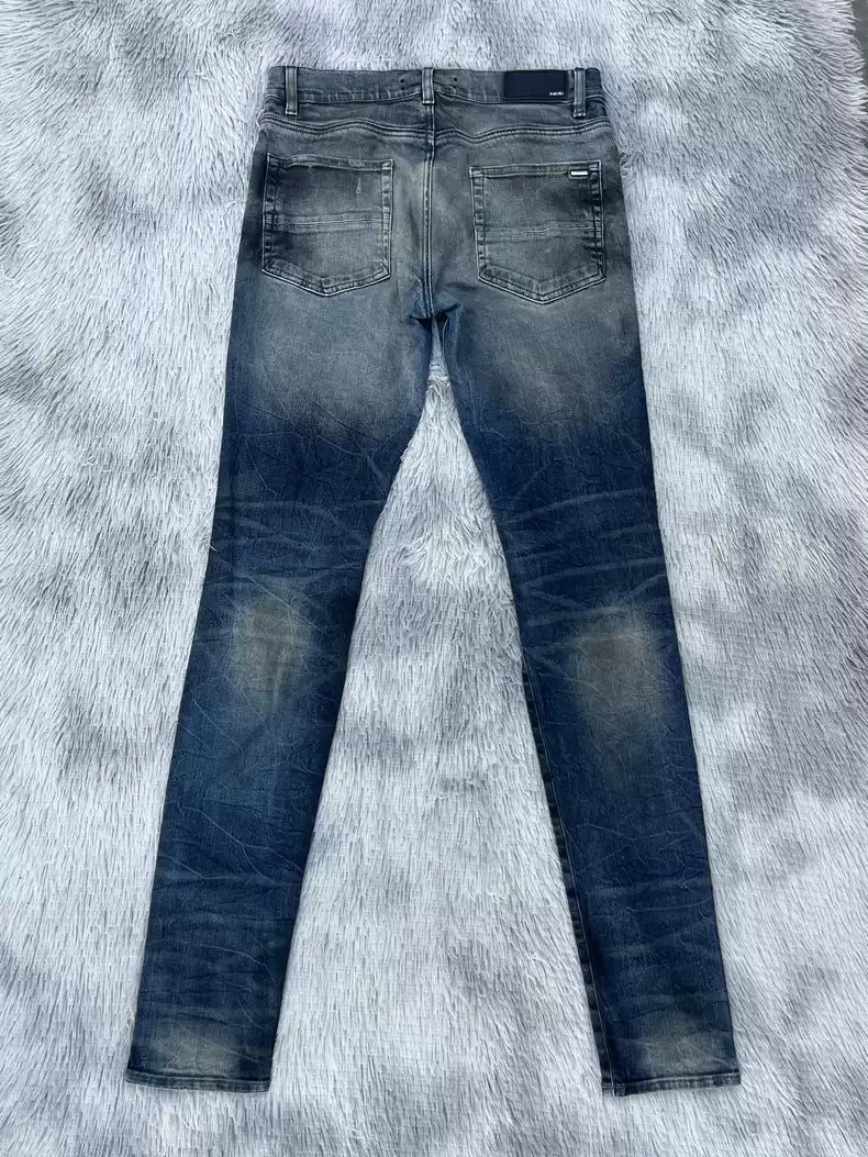 Amiri oil stains, metal washings, worn knees, damaged jeans