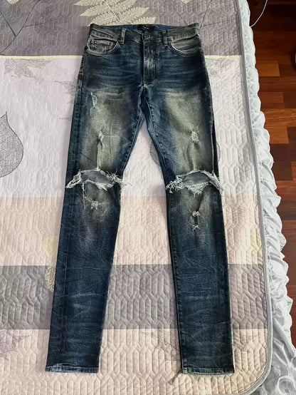 Amiri oil stains, metal washings, worn knees, damaged jeans