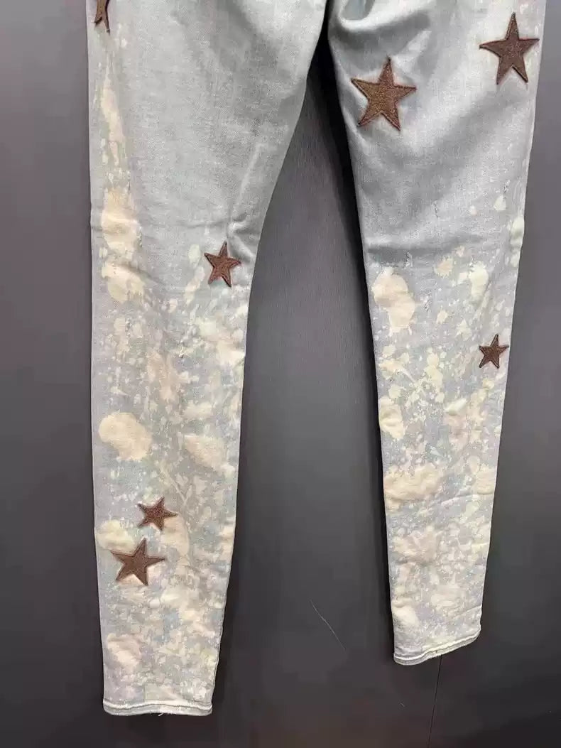 Amiri splashed maple leaf plush washed ice blue jeans