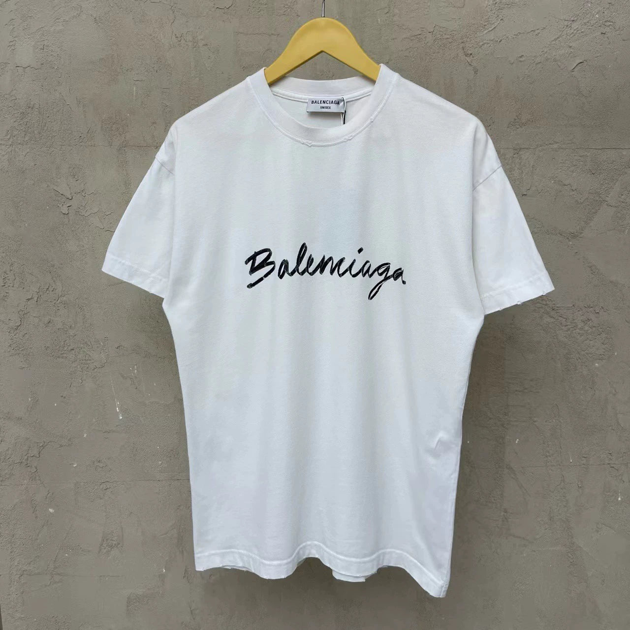 Balenciaga white cursive logo is damaged and worn short sleeved