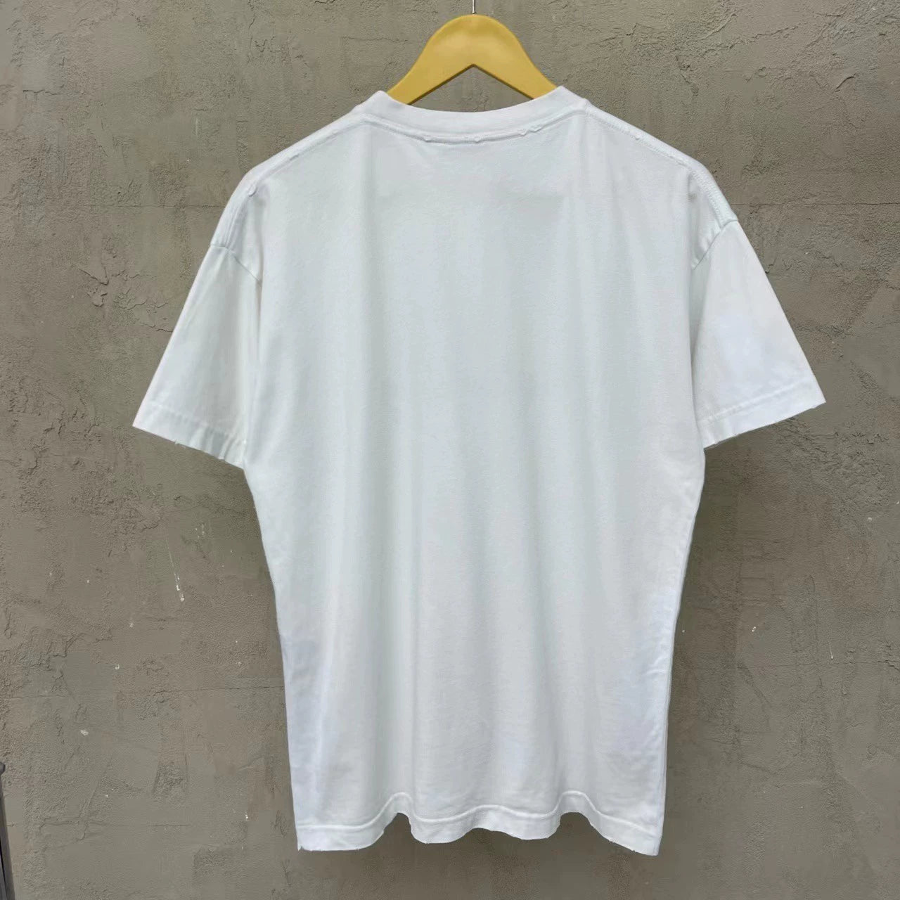 Balenciaga white cursive logo is damaged and worn short sleeved