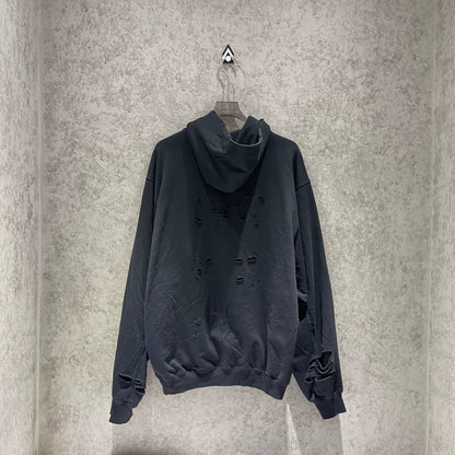 Balenciaga black logo is worn out with holes making a hooded sweatshirt