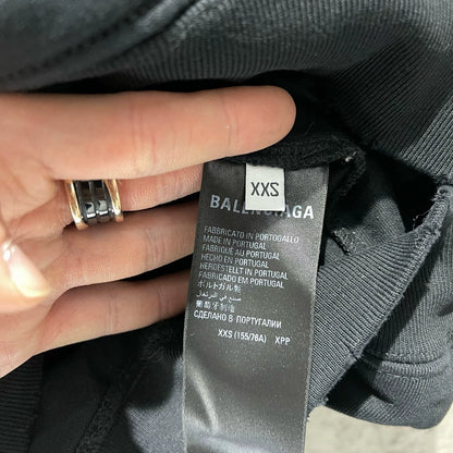 Balenciaga black logo is worn out with holes making a hooded sweatshirt