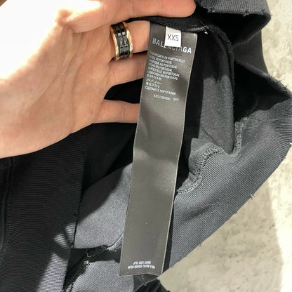 Balenciaga black logo is worn out with holes making a hooded sweatshirt