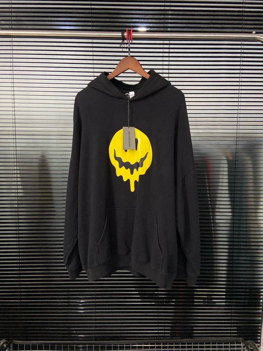 Balenciaga dissolves smiley face behind skull black hooded sweatshirt