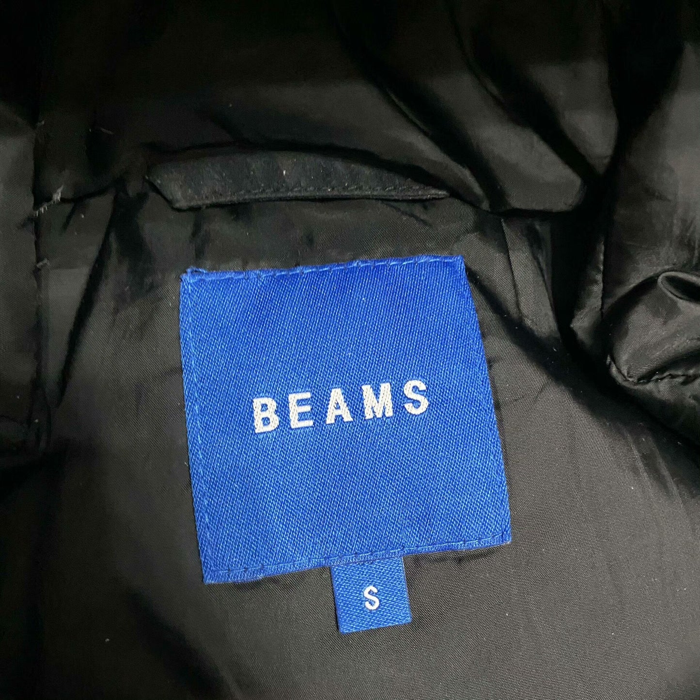 black waterproof puffer jacket by BEAMS