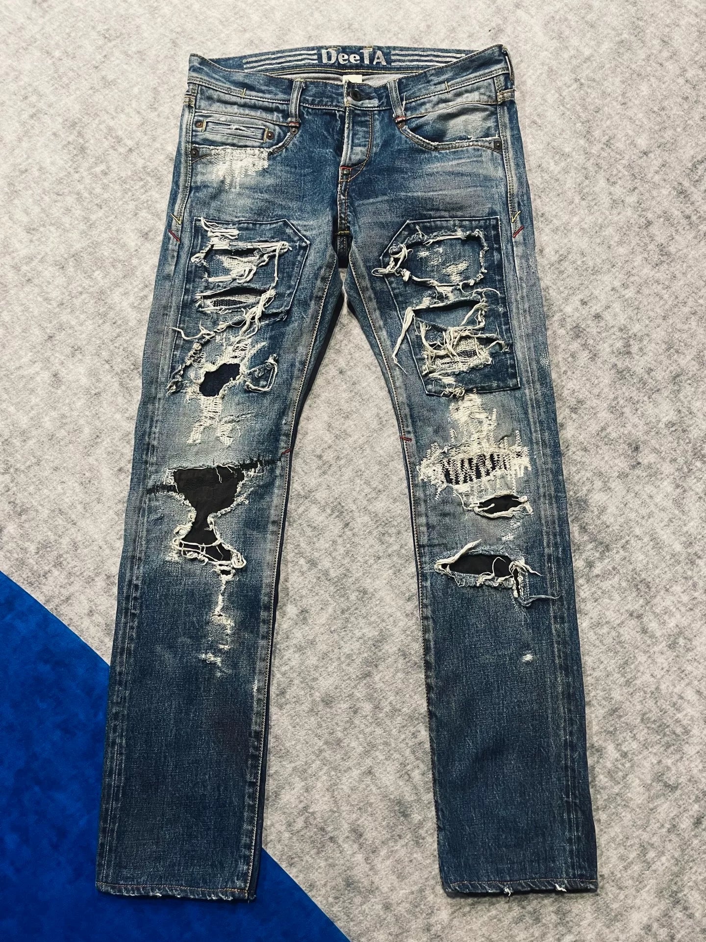 distressed low-rise blue denim jeans