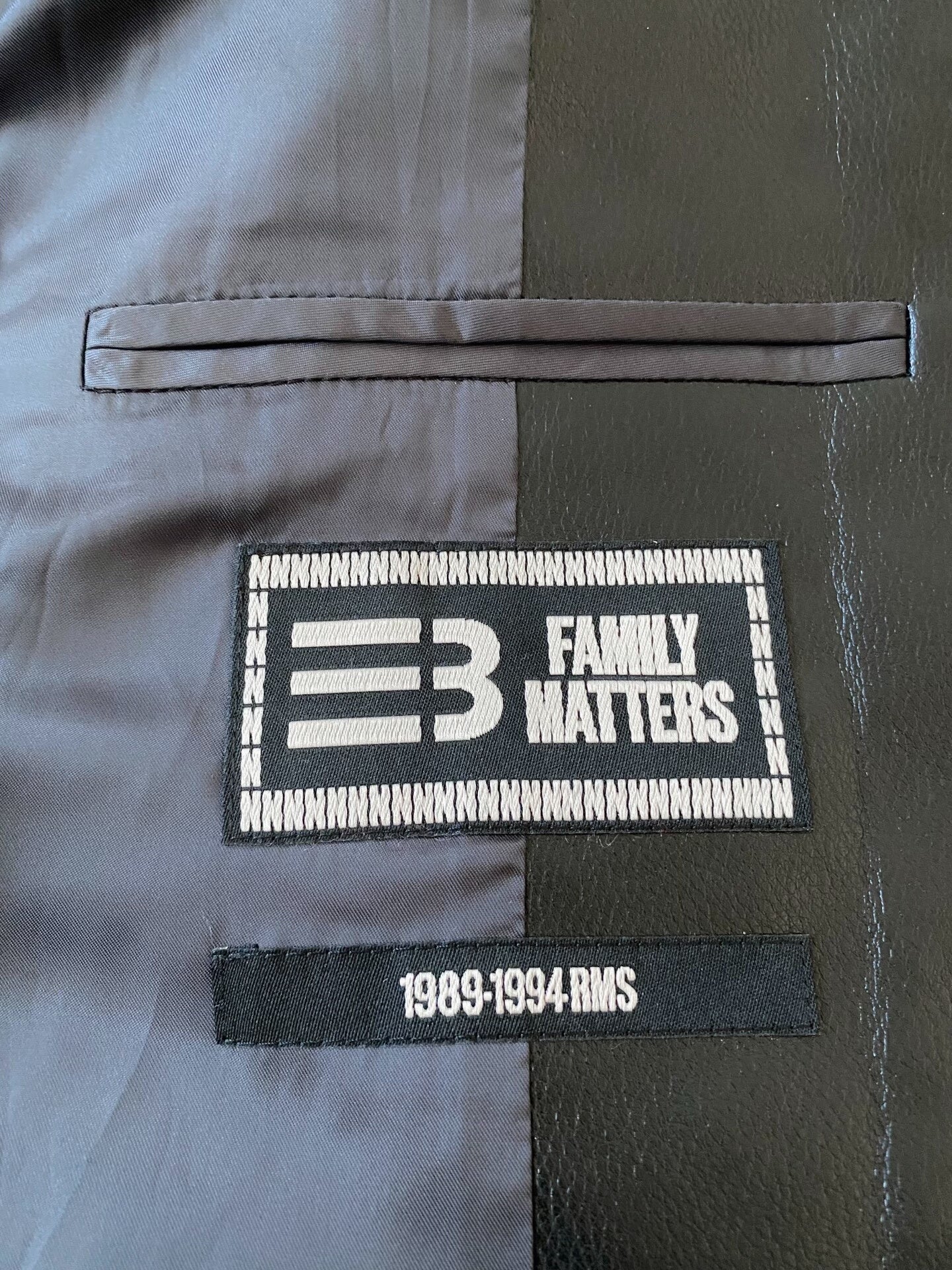 beige baseball jacket with leather sleeves