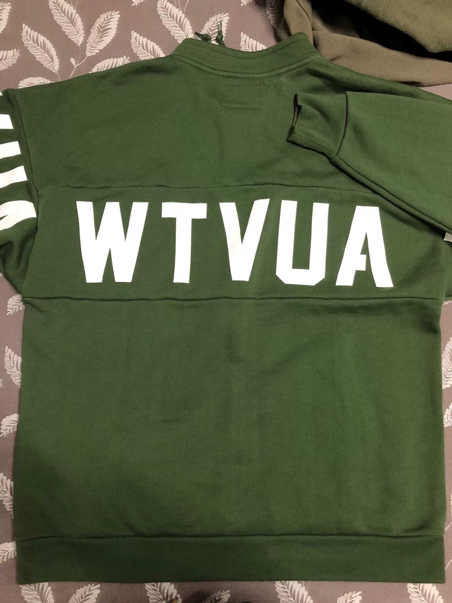 wtaps green pullover sweatshirt with text