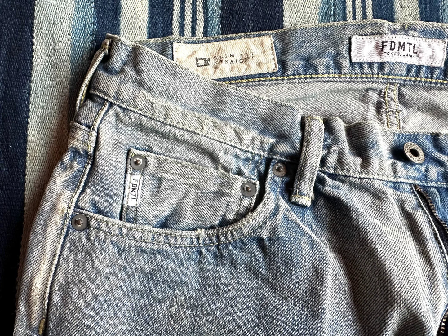 fdmtl slim fit denim distressed patchwork jeans