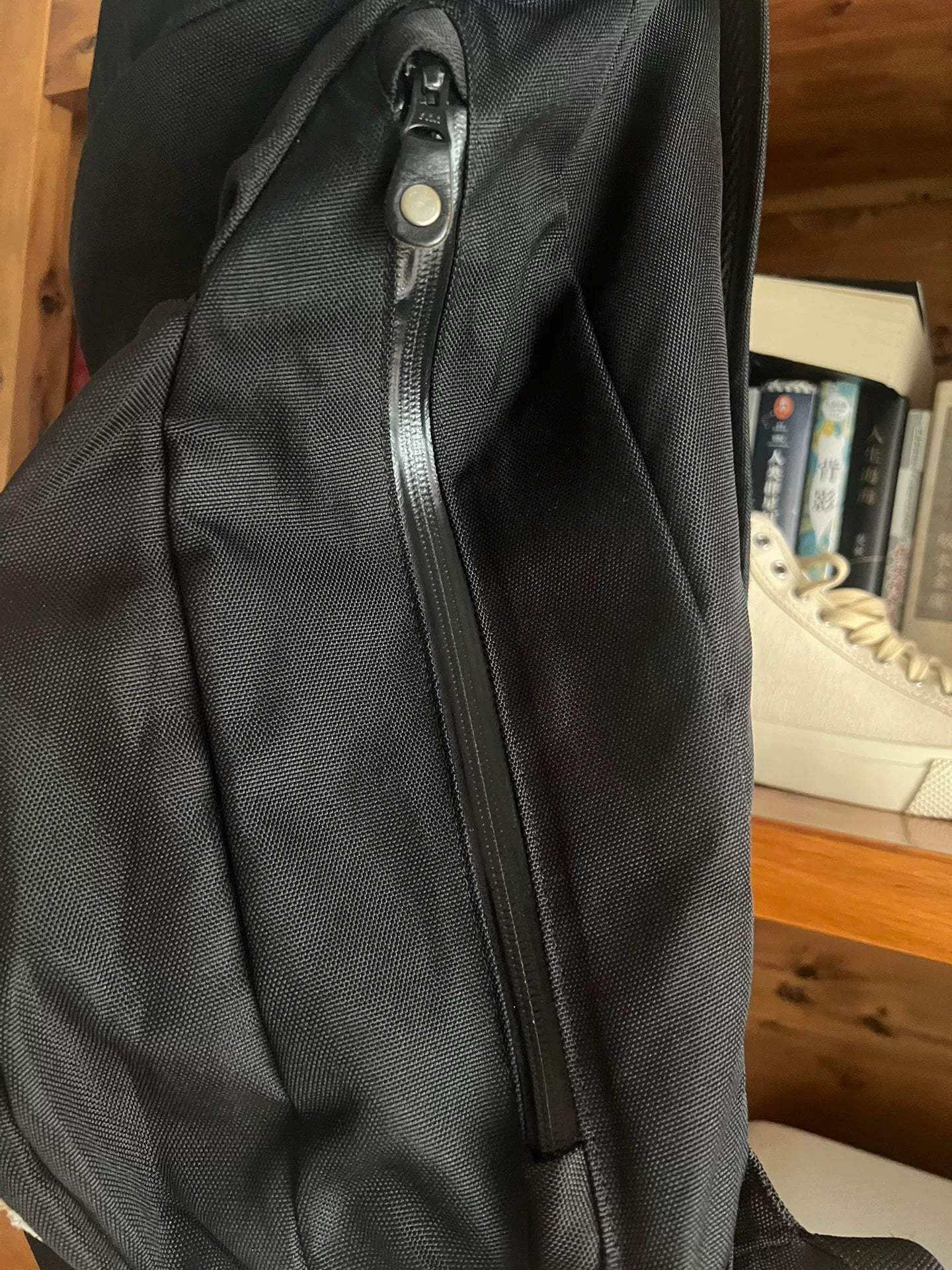 black roll-top backpack with multifunctional pockets