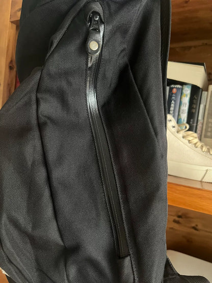 black roll-top backpack with multifunctional pockets