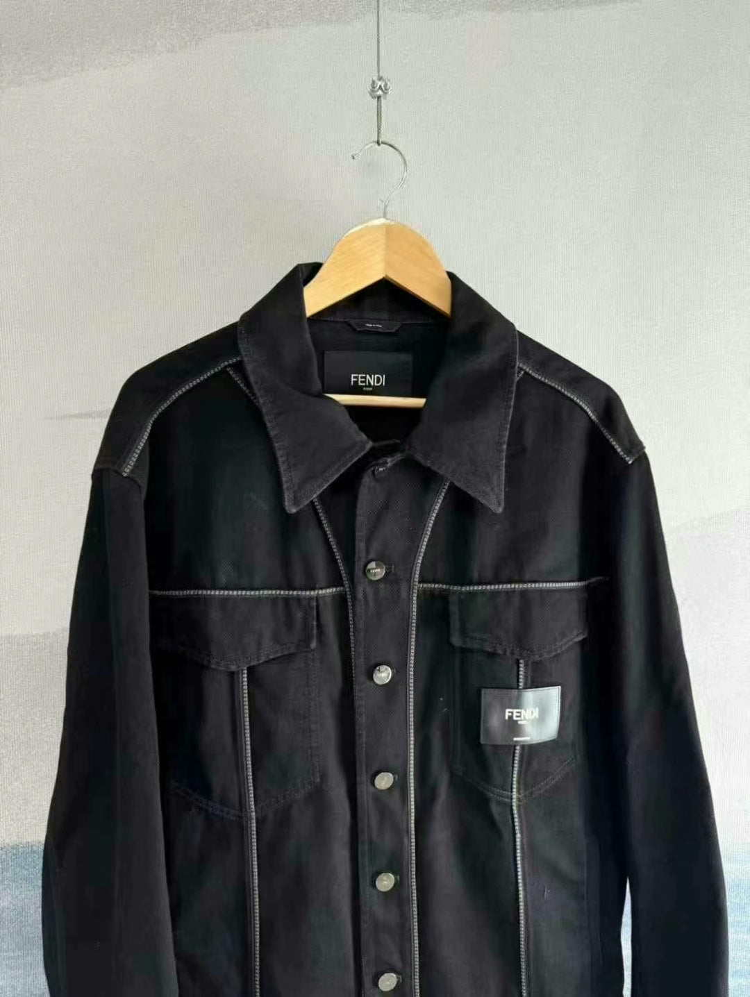 black denim jacket with logo patch