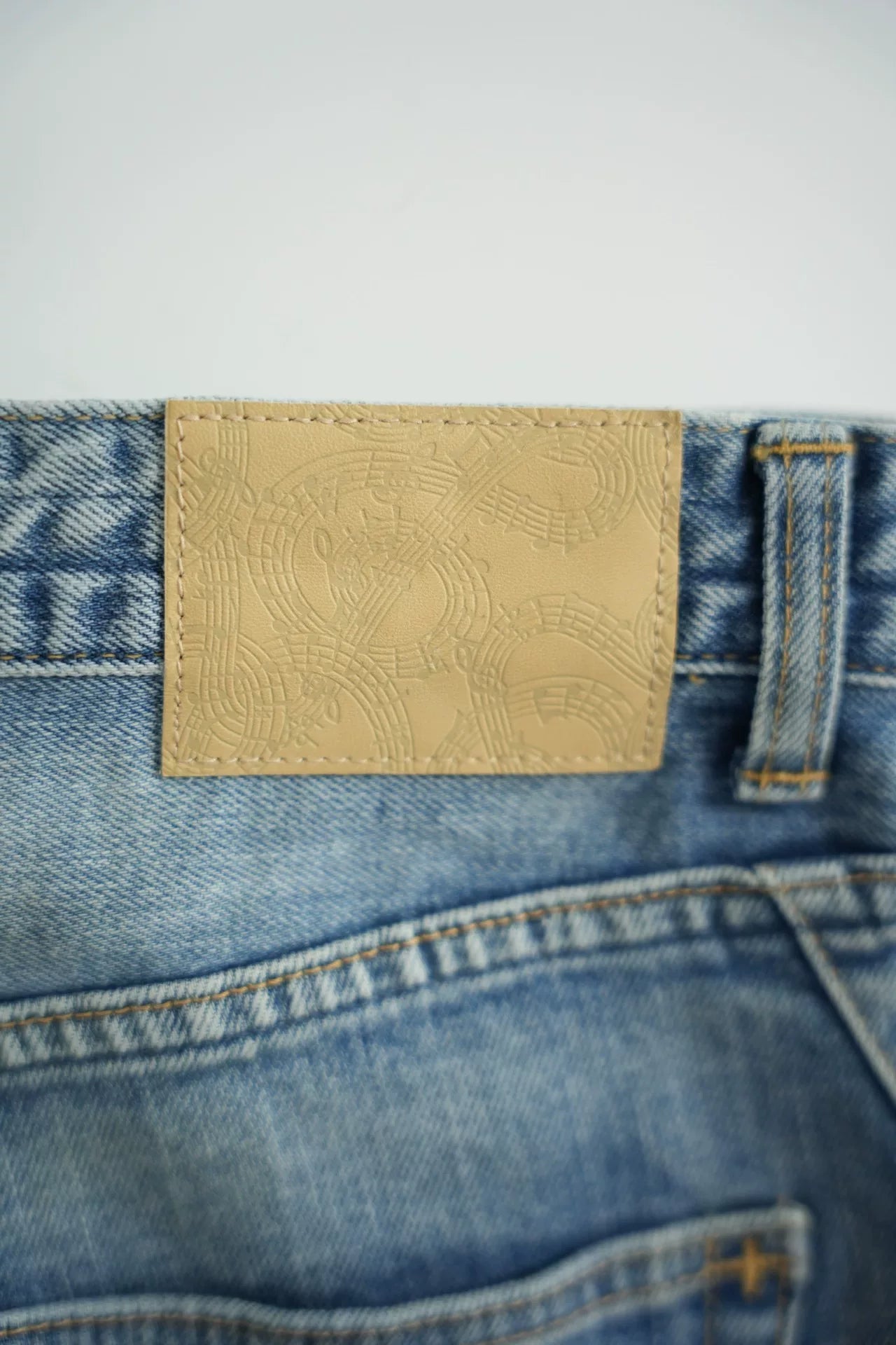 washed denim pants with musical print